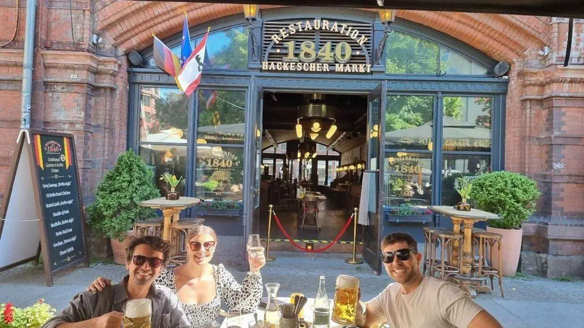 Guide and guests with beer glasses in a Berlin pub on a Berlin WW2 tour of Battle of Berlin sites